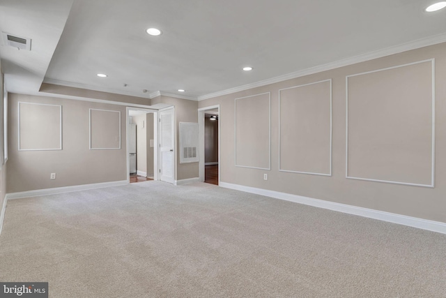 carpeted empty room featuring crown molding