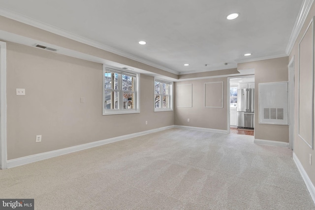 unfurnished room featuring ornamental molding and light carpet