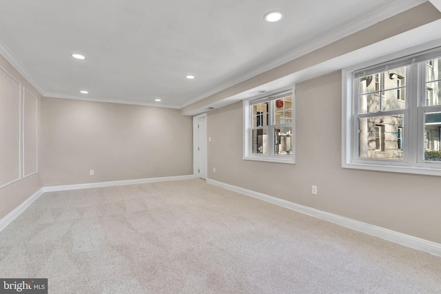 unfurnished room with light colored carpet and crown molding