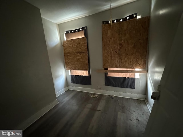 unfurnished room featuring dark wood-type flooring