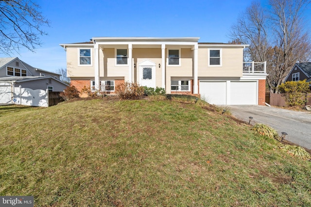 bi-level home featuring a garage and a front yard