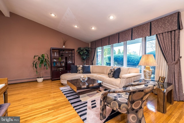 living room featuring a baseboard heating unit, lofted ceiling, and light wood-type flooring