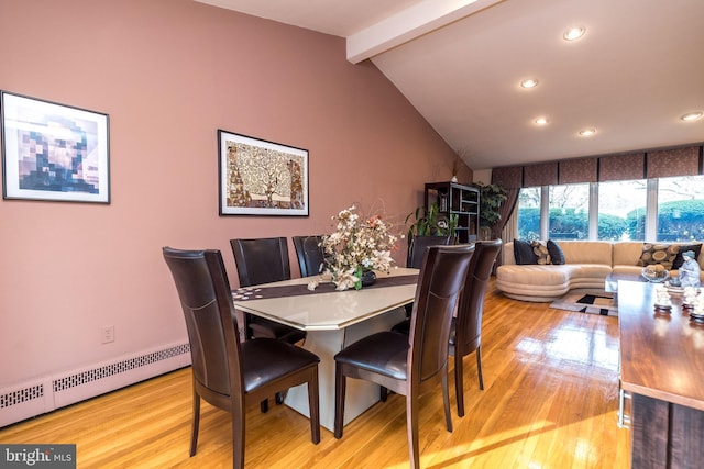 dining space featuring vaulted ceiling with beams, baseboard heating, and light hardwood / wood-style flooring