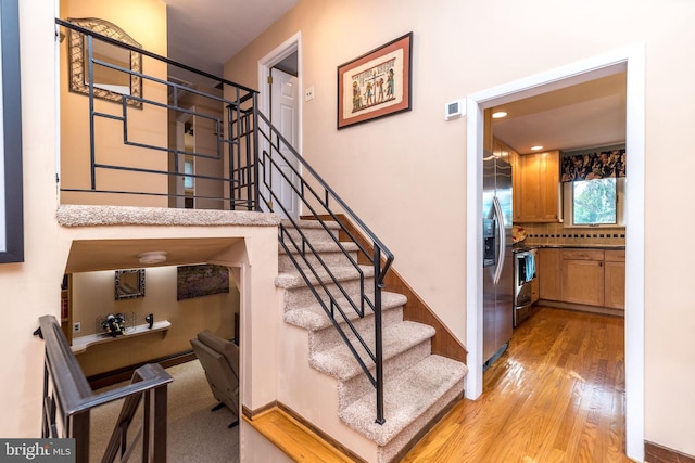 stairs with wood-type flooring