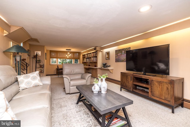 living room with carpet and an inviting chandelier