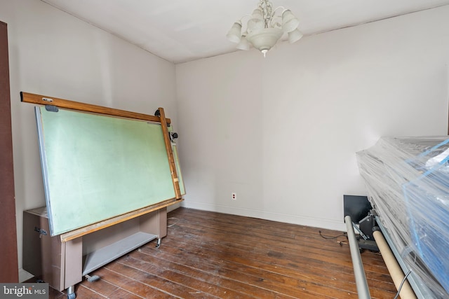 interior space with dark wood-type flooring and a chandelier