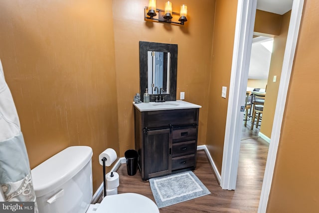 bathroom featuring hardwood / wood-style floors, vanity, and toilet