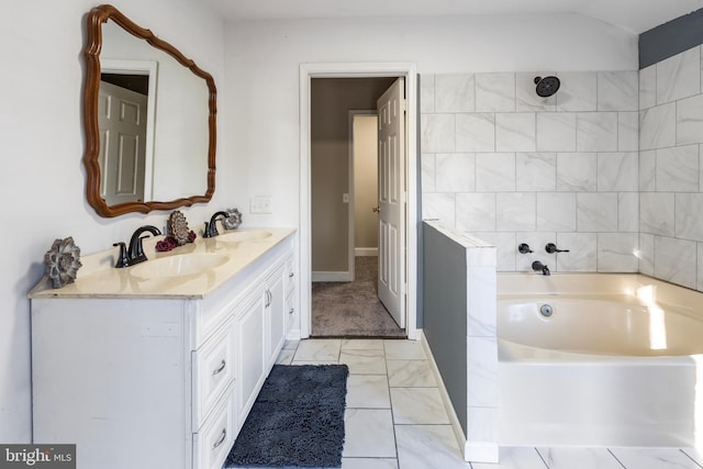 bathroom with vanity and a tub