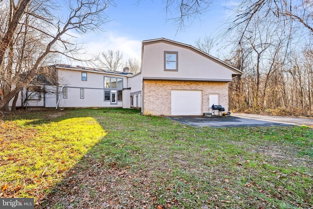 view of side of property featuring a garage and a yard