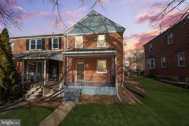 view of front property with a porch and a yard