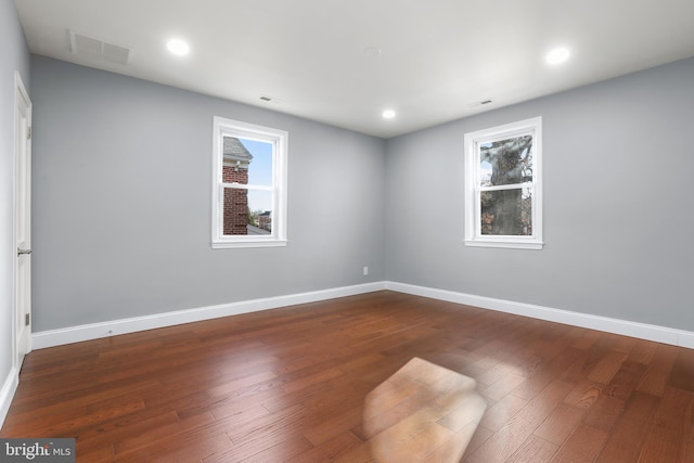 spare room with dark hardwood / wood-style floors