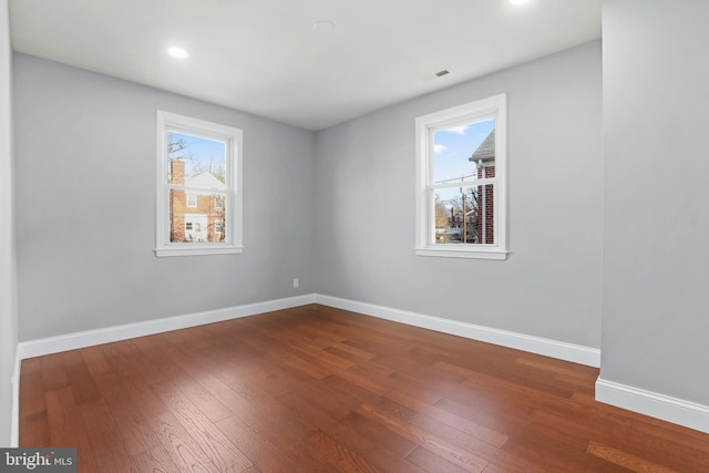 spare room with wood-type flooring