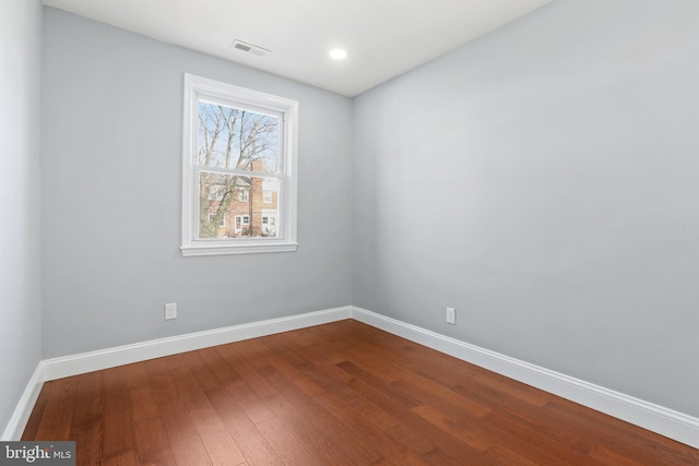 spare room featuring hardwood / wood-style floors