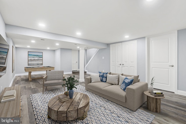 living room with hardwood / wood-style flooring and billiards