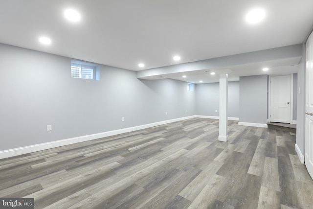 basement with hardwood / wood-style flooring