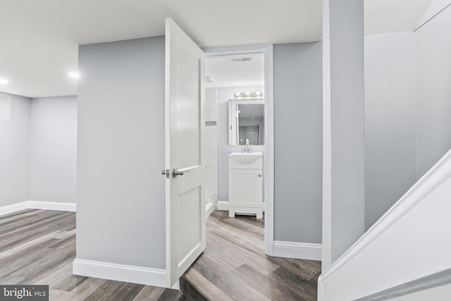 hall featuring sink and wood-type flooring