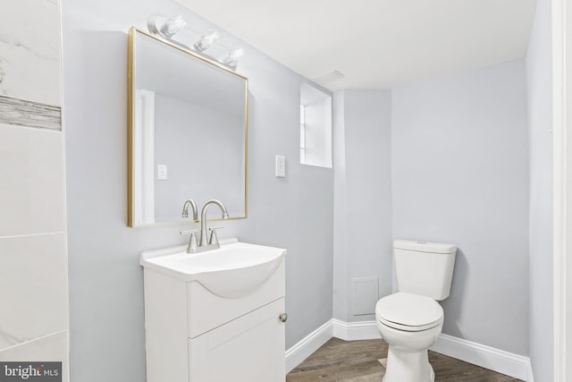 bathroom featuring vanity, toilet, and wood-type flooring