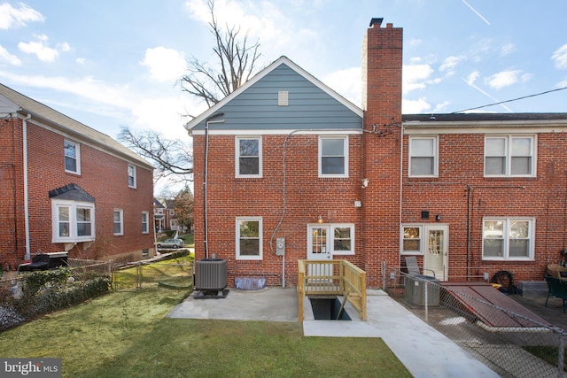 back of property with a yard and cooling unit