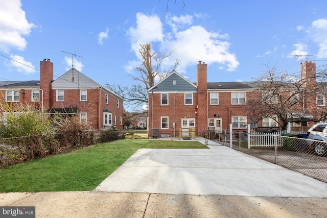 back of house featuring a yard and central AC unit