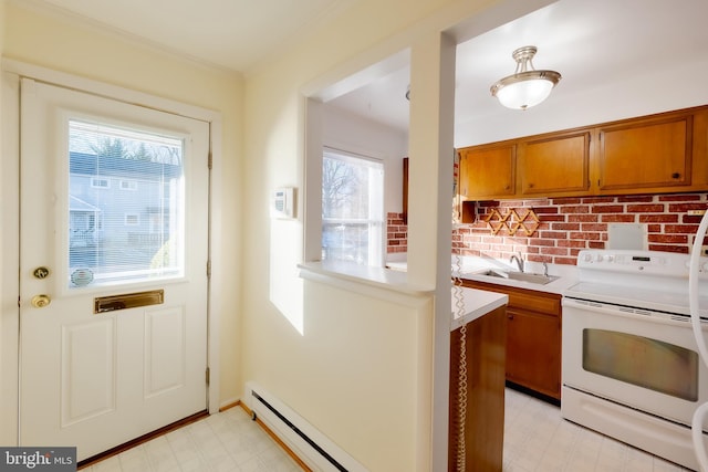 kitchen featuring electric range, plenty of natural light, baseboard heating, and sink