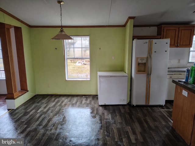 kitchen with fridge, white fridge with ice dispenser, dark hardwood / wood-style floors, and hanging light fixtures