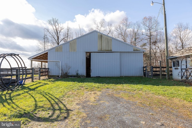 view of outbuilding featuring a lawn