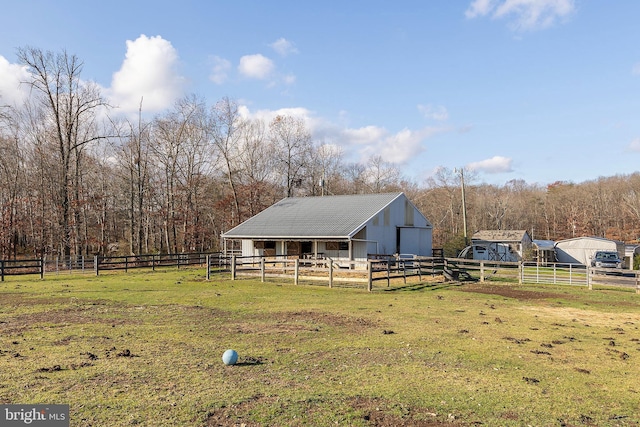 exterior space featuring a rural view and an outdoor structure