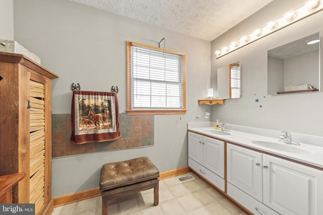 bathroom with vanity and a textured ceiling