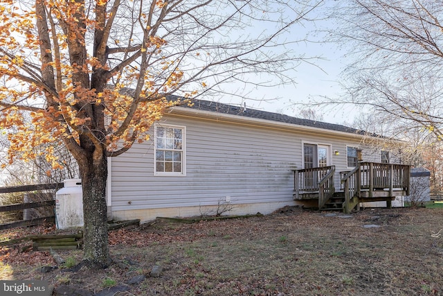 back of house featuring a deck