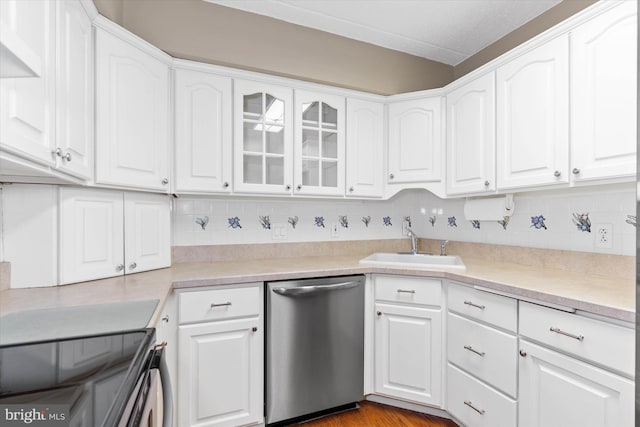 kitchen featuring white cabinets, dishwasher, and tasteful backsplash