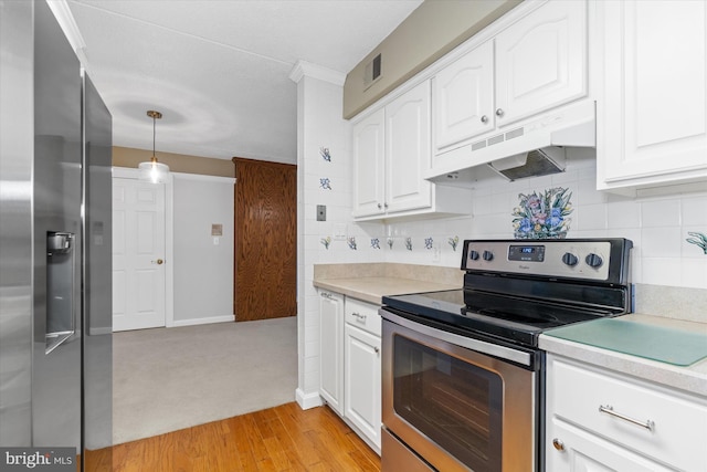 kitchen featuring white cabinets, decorative light fixtures, light hardwood / wood-style floors, and appliances with stainless steel finishes