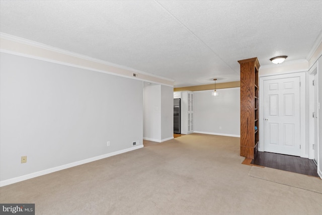 interior space featuring carpet, stainless steel fridge, ornamental molding, and a textured ceiling