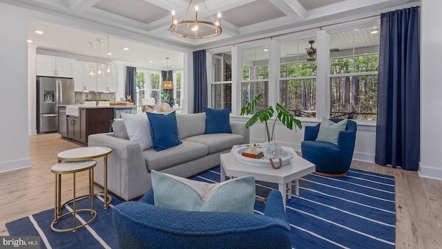 living room with beamed ceiling, ornamental molding, light wood-type flooring, and coffered ceiling