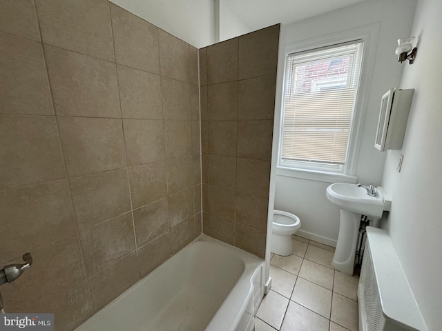 bathroom featuring tile patterned flooring, toilet, and sink