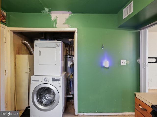 laundry room with stacked washer / drying machine