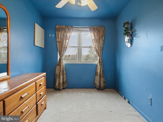 unfurnished bedroom featuring ceiling fan and light carpet