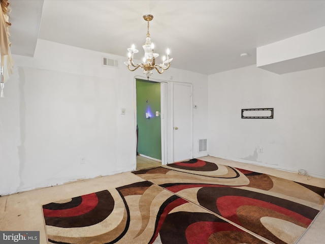 unfurnished room with a chandelier