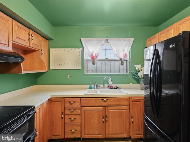 kitchen featuring black fridge with ice dispenser and sink