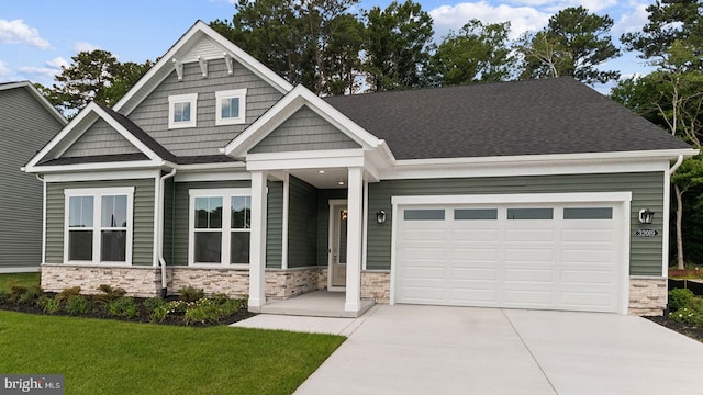 craftsman-style home featuring a garage and a front lawn