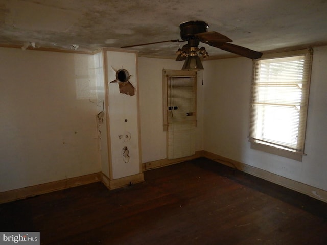 empty room featuring ceiling fan and dark wood-type flooring