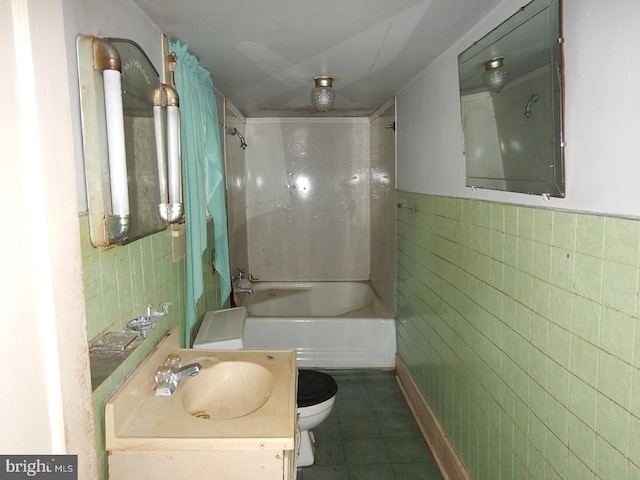 full bathroom with tile patterned floors, vanity, shower / washtub combination, tile walls, and toilet