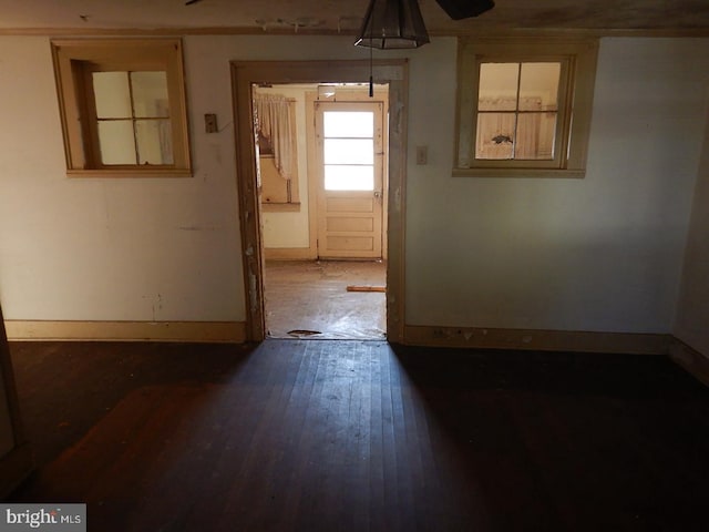 unfurnished room with dark hardwood / wood-style flooring