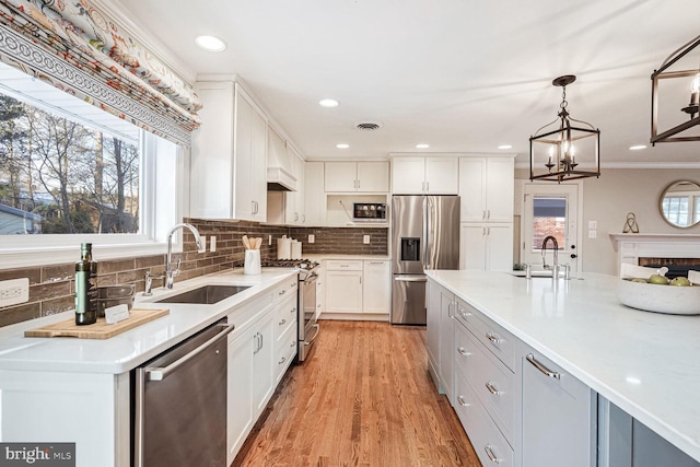 kitchen with sink, white cabinetry, and stainless steel appliances