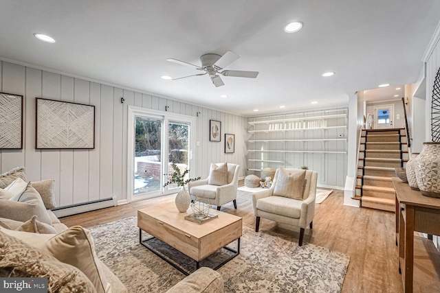 living room with ceiling fan, light hardwood / wood-style floors, ornamental molding, and a baseboard radiator