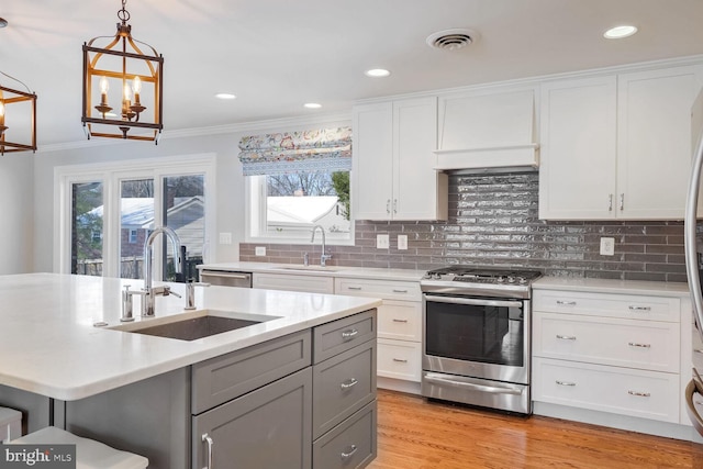 kitchen featuring gray cabinets, stainless steel appliances, white cabinetry, and sink