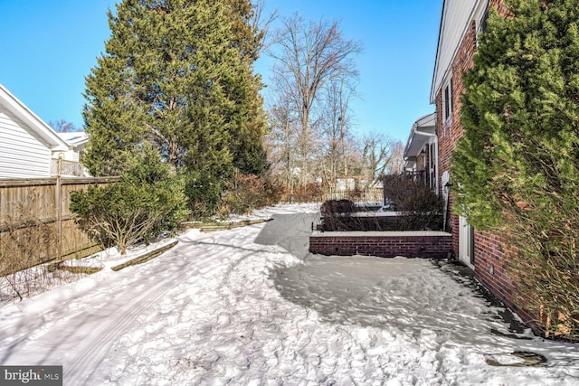 view of yard layered in snow