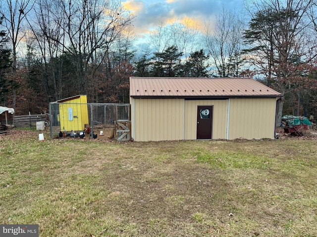 view of outbuilding with a yard