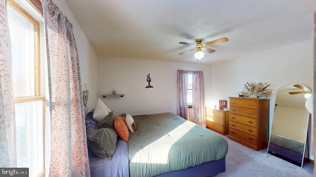 bedroom with ceiling fan and light colored carpet