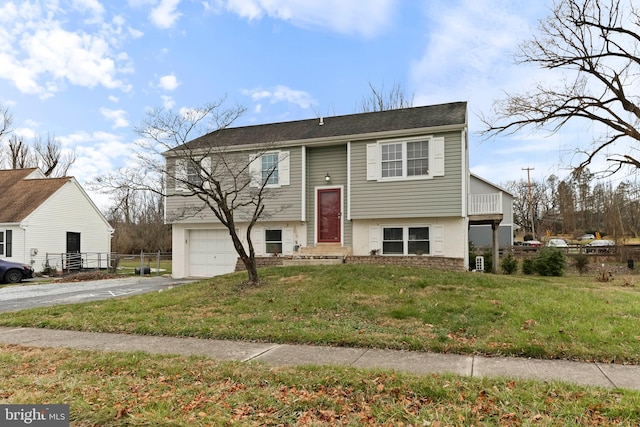 raised ranch with a garage and a front lawn