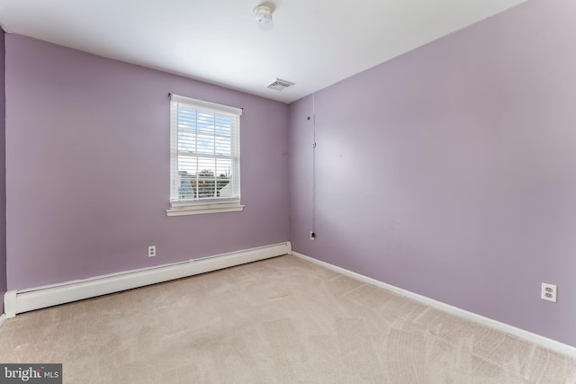 carpeted empty room with a baseboard heating unit